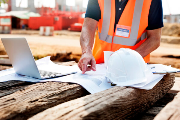 closeup contractor construction site pointing plan wooden sleeper